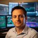 David Okafor portrait in a professional trading environment with computers in the background